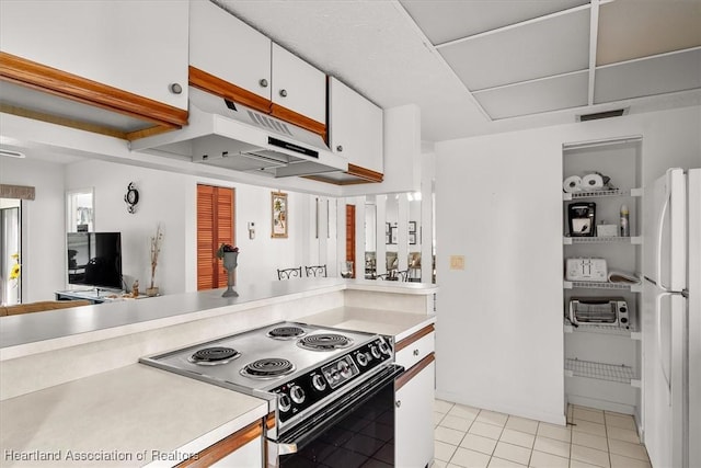 4989 Casablanca Cir Unit J-3, Sebring, FL 33870 - kitchen with white cabinetry, light tile patterned floors, black electric range, and white refrigerator