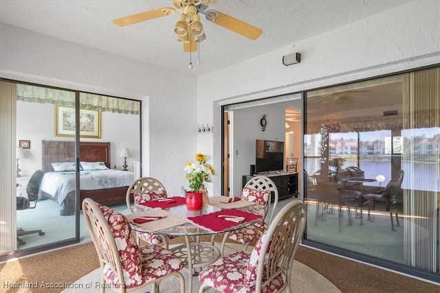 4989 Casablanca Cir Unit J-3, Sebring, FL 33870 - dining room featuring ceiling fan, carpet floors, and a textured ceiling