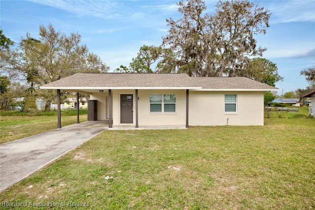 ranch-style home with an attached carport, roof with shingles, driveway, and a front yard