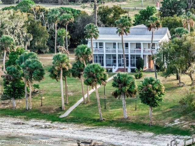 view of dock featuring a water view and a lawn