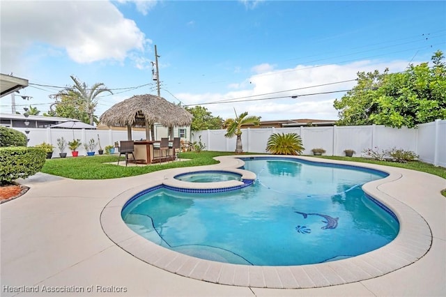 view of swimming pool with a patio, a lawn, a fenced backyard, and a pool with connected hot tub