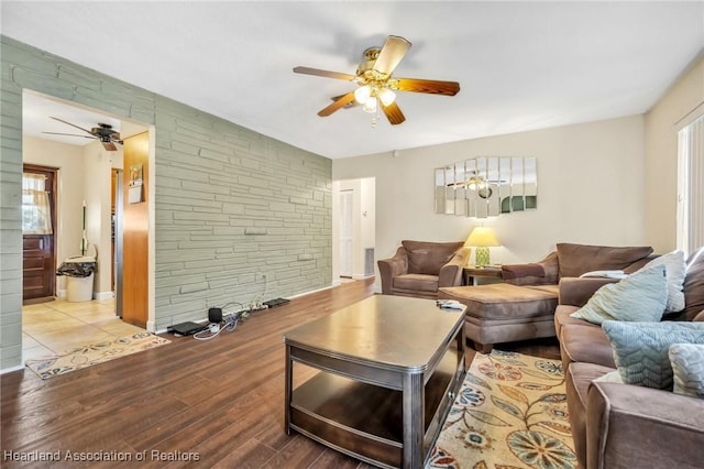 living area with ceiling fan and wood finished floors