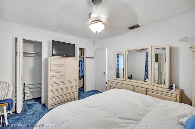 bedroom featuring dark colored carpet and visible vents