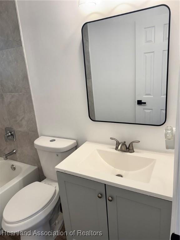 full bathroom featuring vanity, toilet, and tiled shower / bath