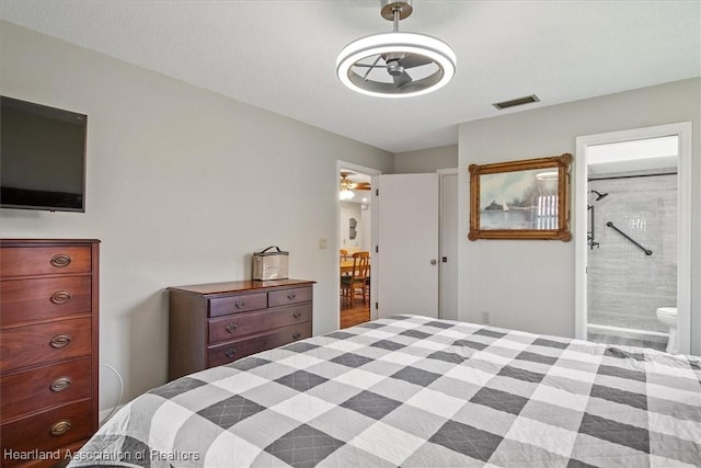 bedroom with ensuite bath and visible vents