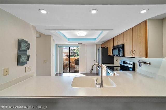 kitchen with recessed lighting, stainless steel electric range, a sink, black microwave, and a raised ceiling