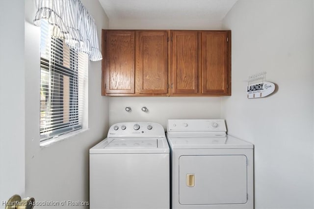 laundry room featuring washer and clothes dryer and cabinet space