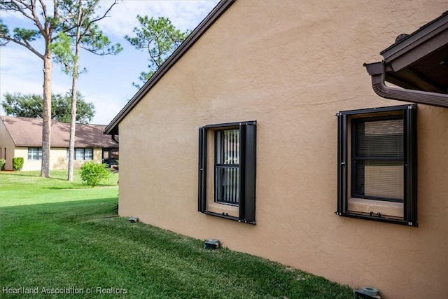 view of home's exterior featuring a yard and stucco siding