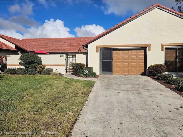 mediterranean / spanish house with a front yard and a garage