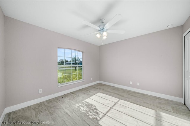 unfurnished room with ceiling fan