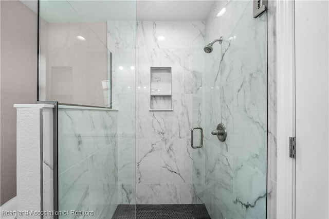 bathroom featuring a shower with shower door