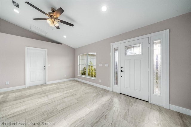 foyer entrance with ceiling fan and lofted ceiling