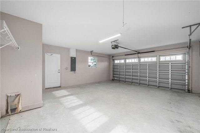 garage with a garage door opener and electric panel