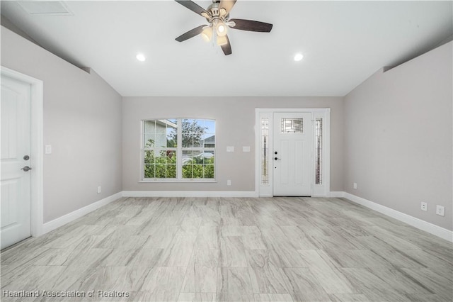 entrance foyer with ceiling fan and vaulted ceiling