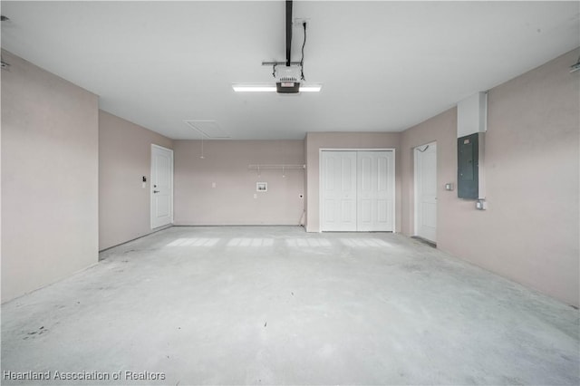 garage with a garage door opener and electric panel