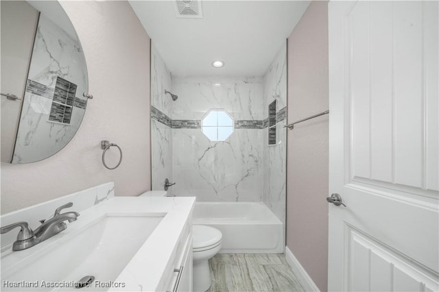 full bathroom with tiled shower / bath, vanity, and toilet