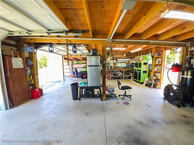 1503 Goldbud St, Lake Placid, FL 33852 - garage featuring freestanding refrigerator and a workshop area