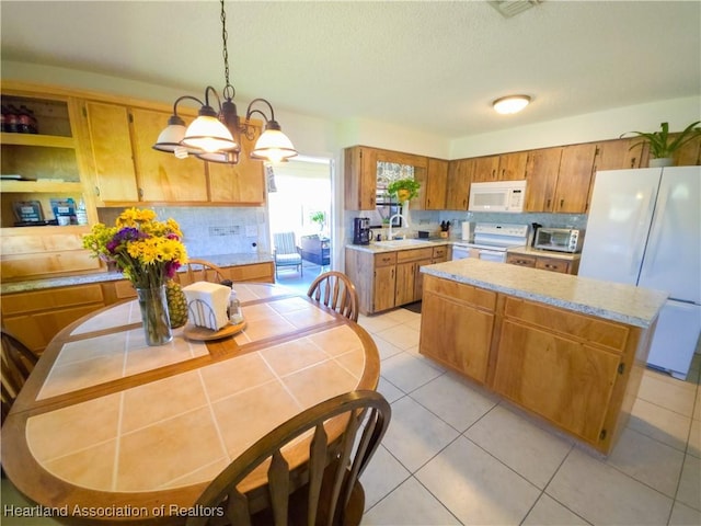 1503 Goldbud St, Lake Placid, FL 33852 - kitchen with tasteful backsplash, a sink, white appliances, light countertops, and a kitchen island