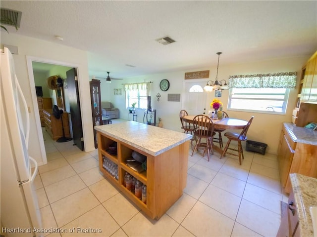 1503 Goldbud St, Lake Placid, FL 33852 - kitchen featuring a center island, light countertops, visible vents, and freestanding refrigerator