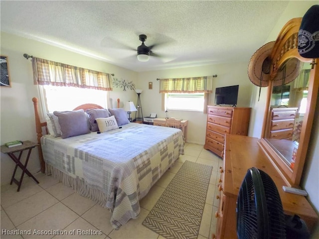 1503 Goldbud St, Lake Placid, FL 33852 - bedroom featuring light tile patterned flooring, a textured ceiling, and a ceiling fan
