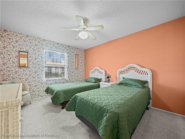 carpeted bedroom with ceiling fan and a textured ceiling