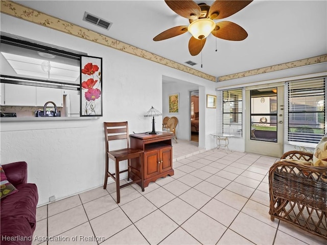 interior space featuring ceiling fan and light tile patterned floors