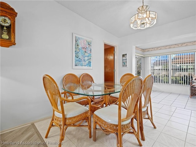 dining room with light tile patterned floors and a chandelier