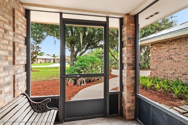 entryway featuring brick wall