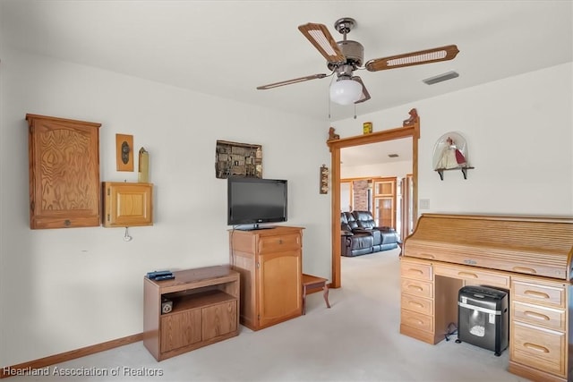 home office featuring ceiling fan and light carpet