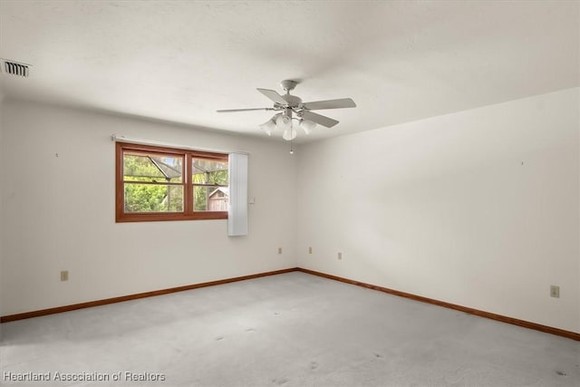 spare room featuring ceiling fan and carpet floors