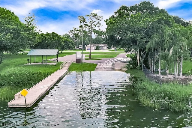 surrounding community with a gazebo, a water view, and a dock