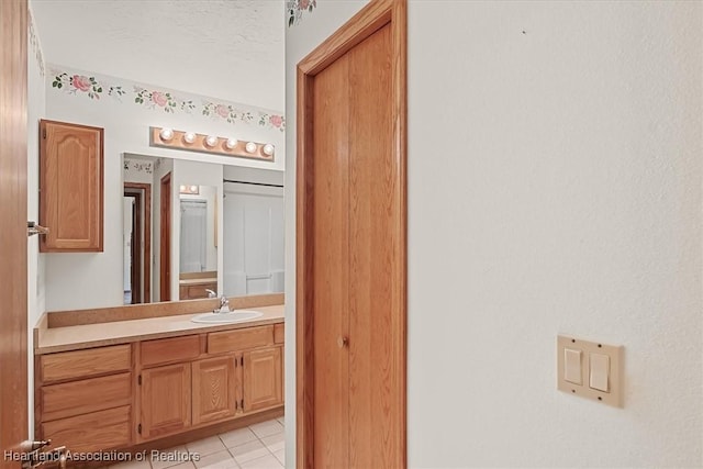 bathroom featuring tile patterned flooring and vanity