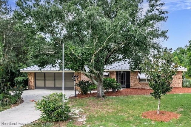 view of front of house featuring a garage and a front lawn