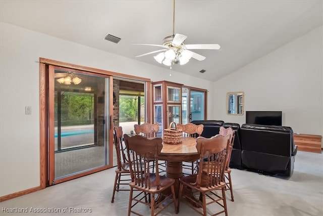 carpeted dining space featuring vaulted ceiling and ceiling fan