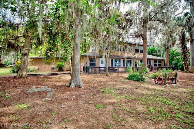 back of property with a wooden deck