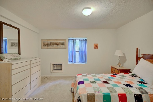 bedroom featuring a textured ceiling, an AC wall unit, and carpet flooring