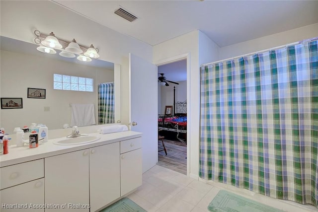 bathroom featuring visible vents, vanity, a shower with shower curtain, and tile patterned floors