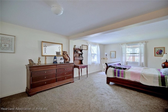 bedroom featuring carpet floors and baseboards