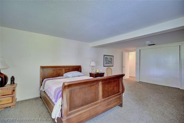 carpeted bedroom with a textured ceiling