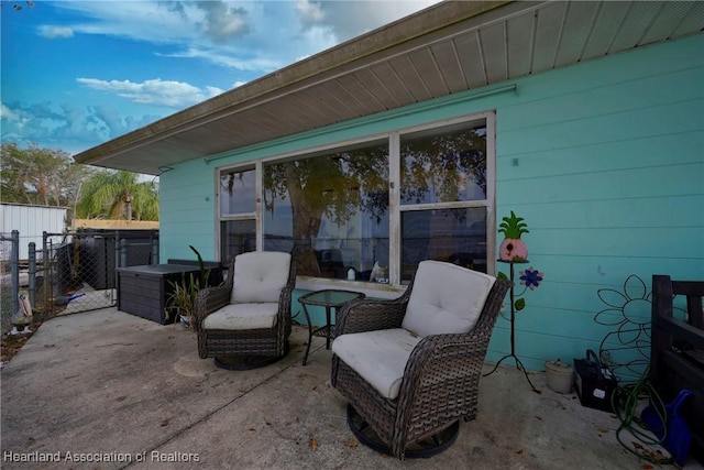 view of patio with a gate and fence