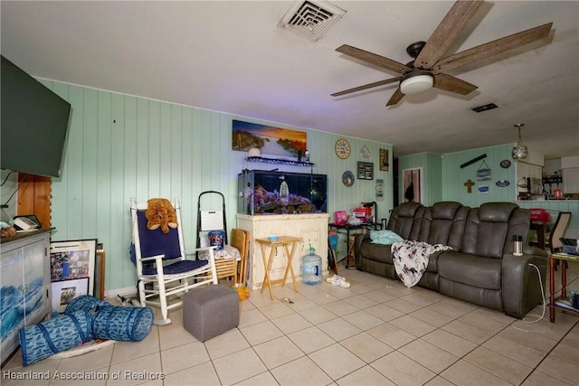 tiled living room with ceiling fan and visible vents