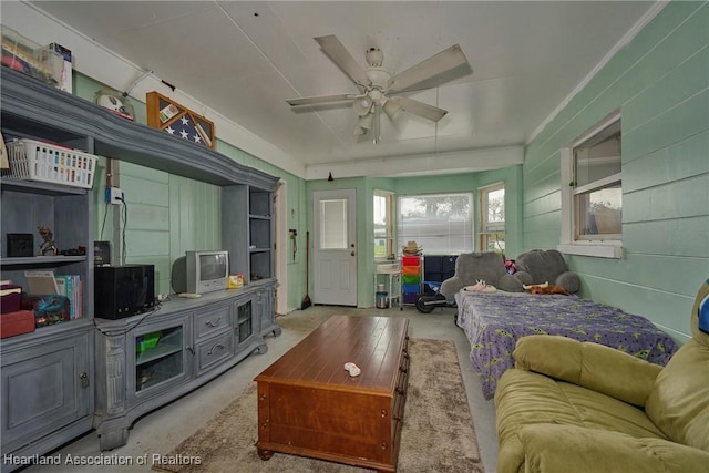 living room featuring unfinished concrete flooring and ceiling fan