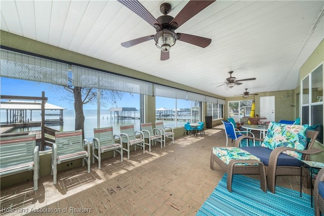 560 Lake June Rd, Lake Placid, FL 33852 - sunroom featuring outdoor dining space, a water view, and a ceiling fan
