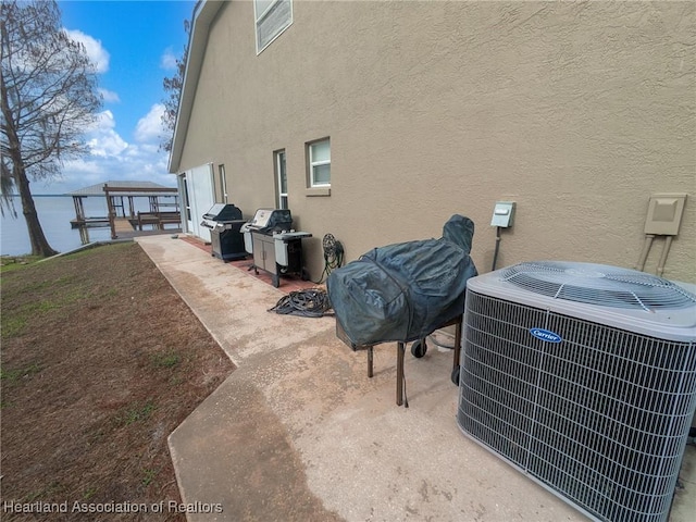 560 Lake June Rd, Lake Placid, FL 33852 - exterior space featuring stucco siding, central AC unit, a gazebo, and a patio area