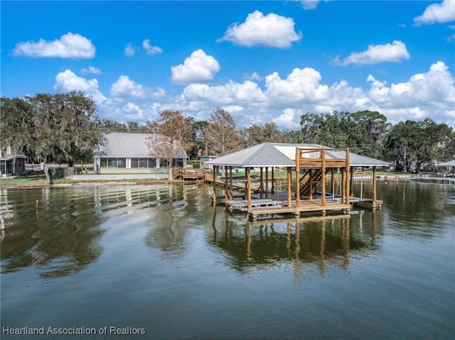 dock area with a water view and boat lift