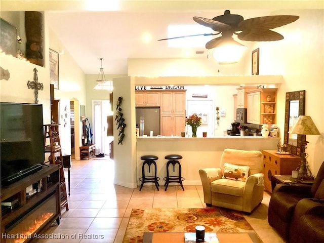 tiled living room with a towering ceiling and ceiling fan