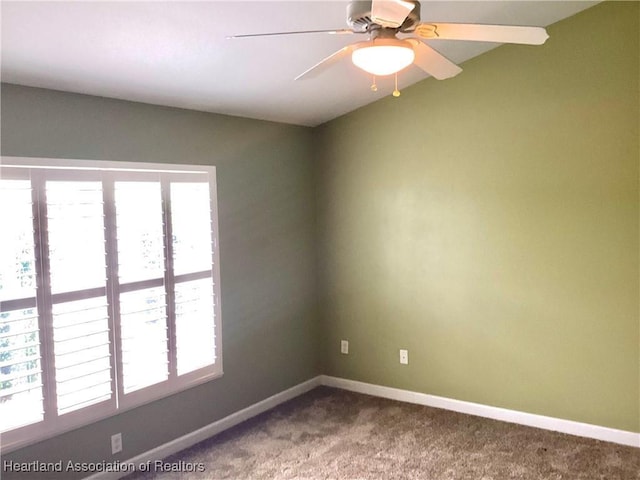 unfurnished room with ceiling fan and carpet floors