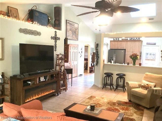 tiled living room with high vaulted ceiling and ceiling fan