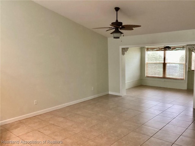 tiled empty room featuring ceiling fan