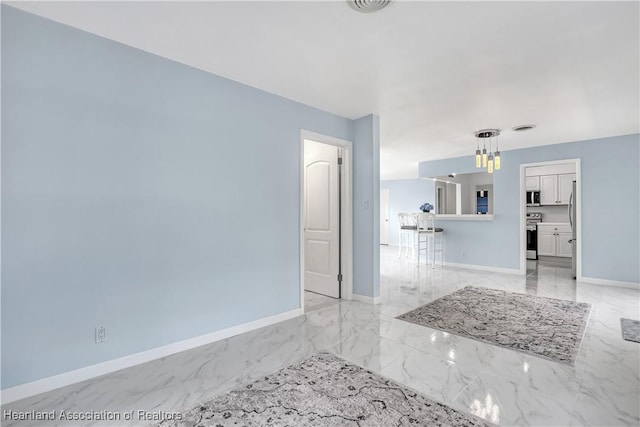 115 Elwa Pl, West Palm Beach, FL 33405 - spare room with a chandelier and light marble finish flooring